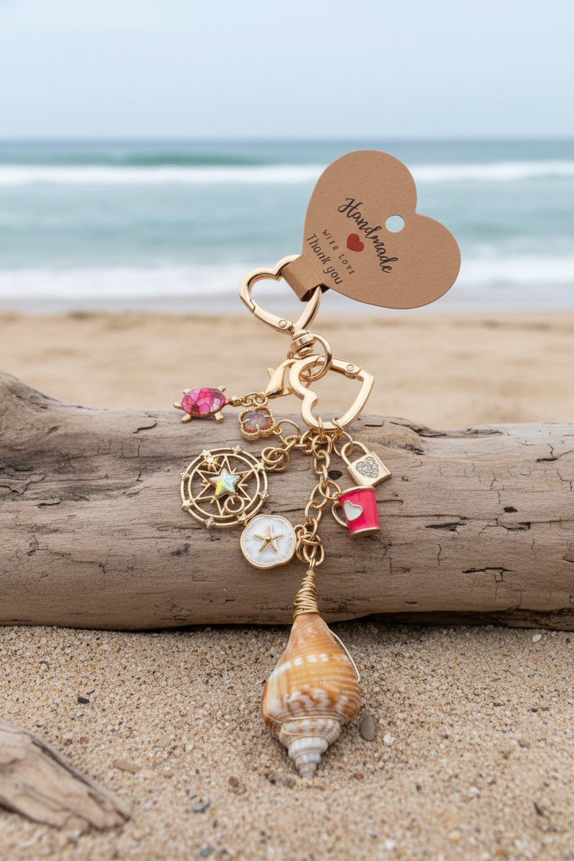 Conch Shell Compass Charm Cluster detail on white surface