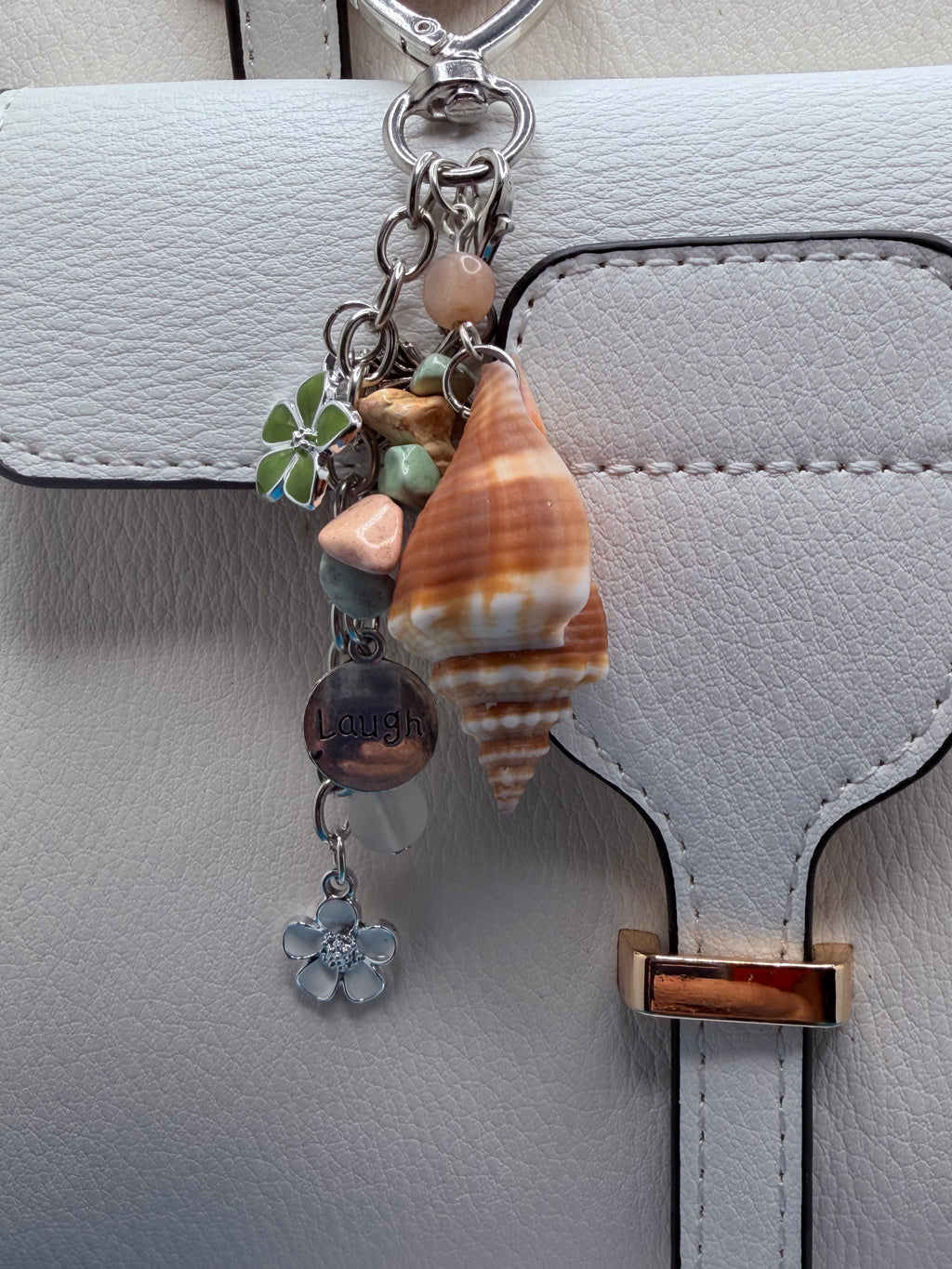 Florida conch shell Laugh bag charm full view on white tote bag