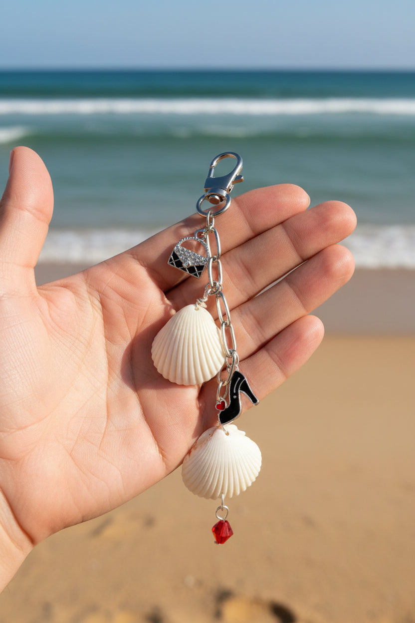Shells and Stilettos scallop shell bag charm with quarter for scale on blue background showing full charm