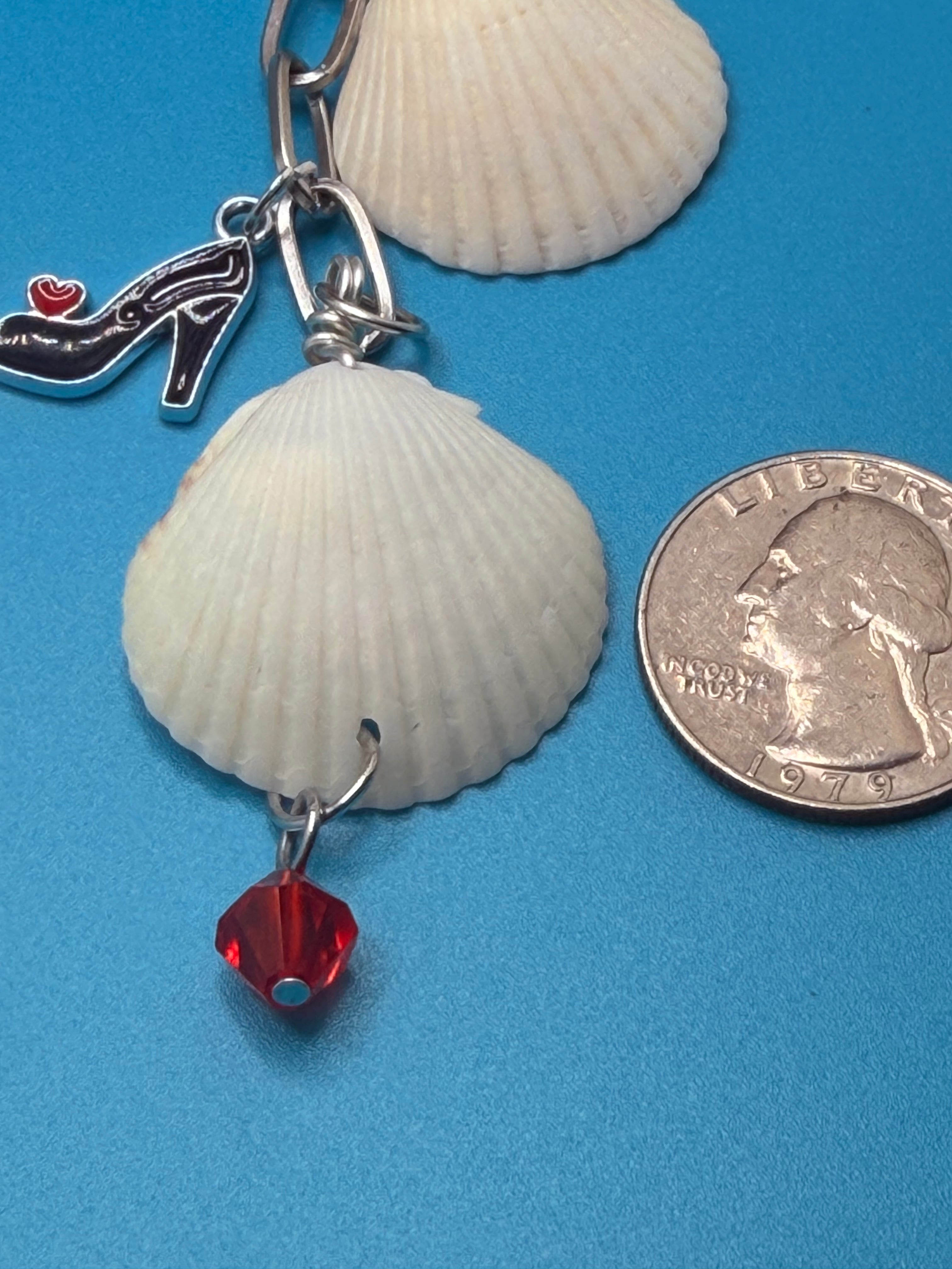 Shells and Stilettos scallop shell bag charm full view on woven straw tote bag