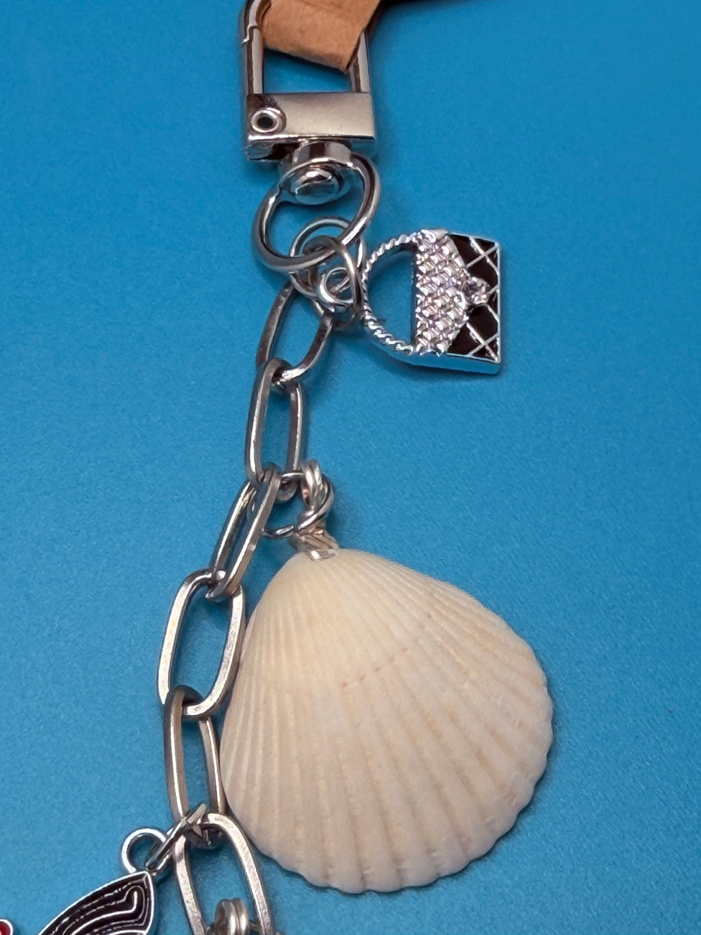 Shells and Stilettos scallop shell bag charm styled on woven straw bag