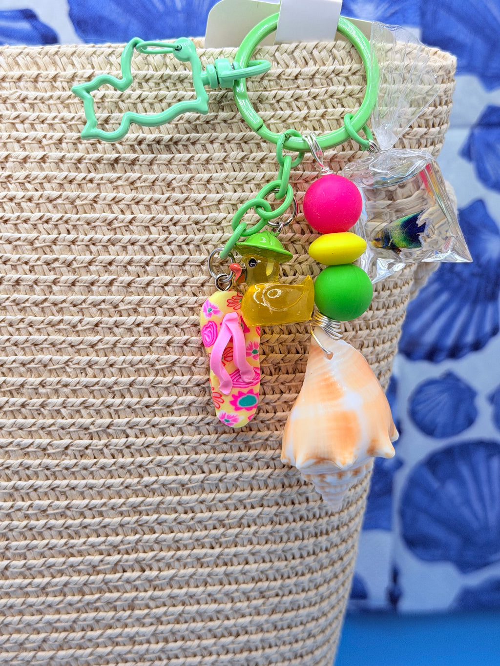Florida Fighting Conch bag charm with neon beads and summer charms on blue background