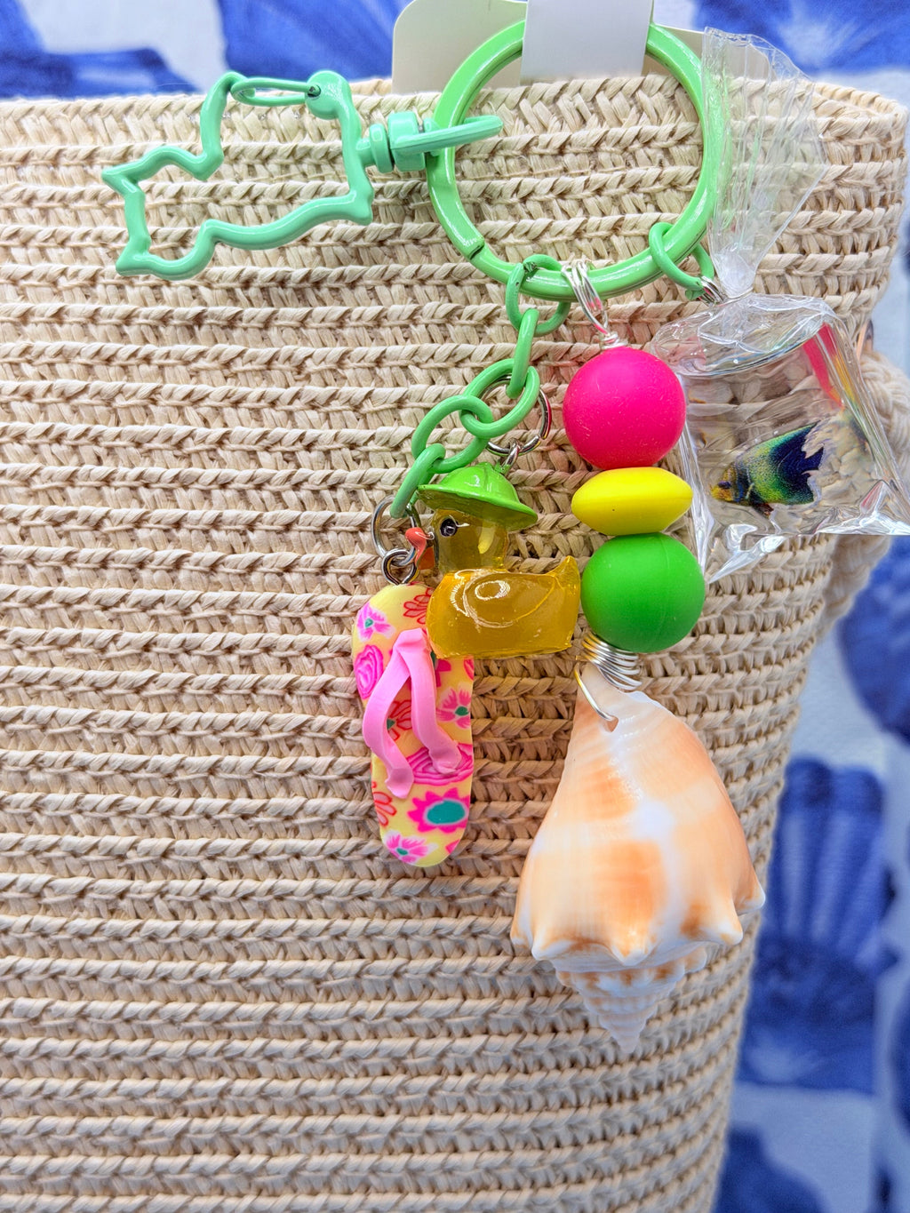 Florida Fighting Conch bag charm styled on woven straw beach bag