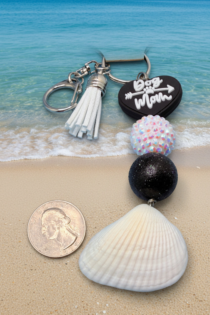 Dog Mom ark shell keychain styled on woven straw bag with shell print background