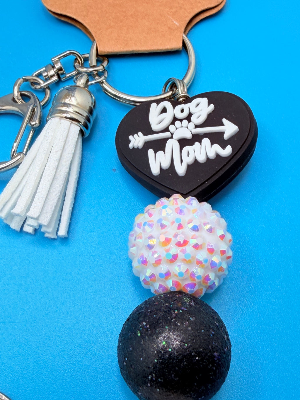Dog Mom ark shell keychain close-up on woven straw bag showing disco ball bead detail