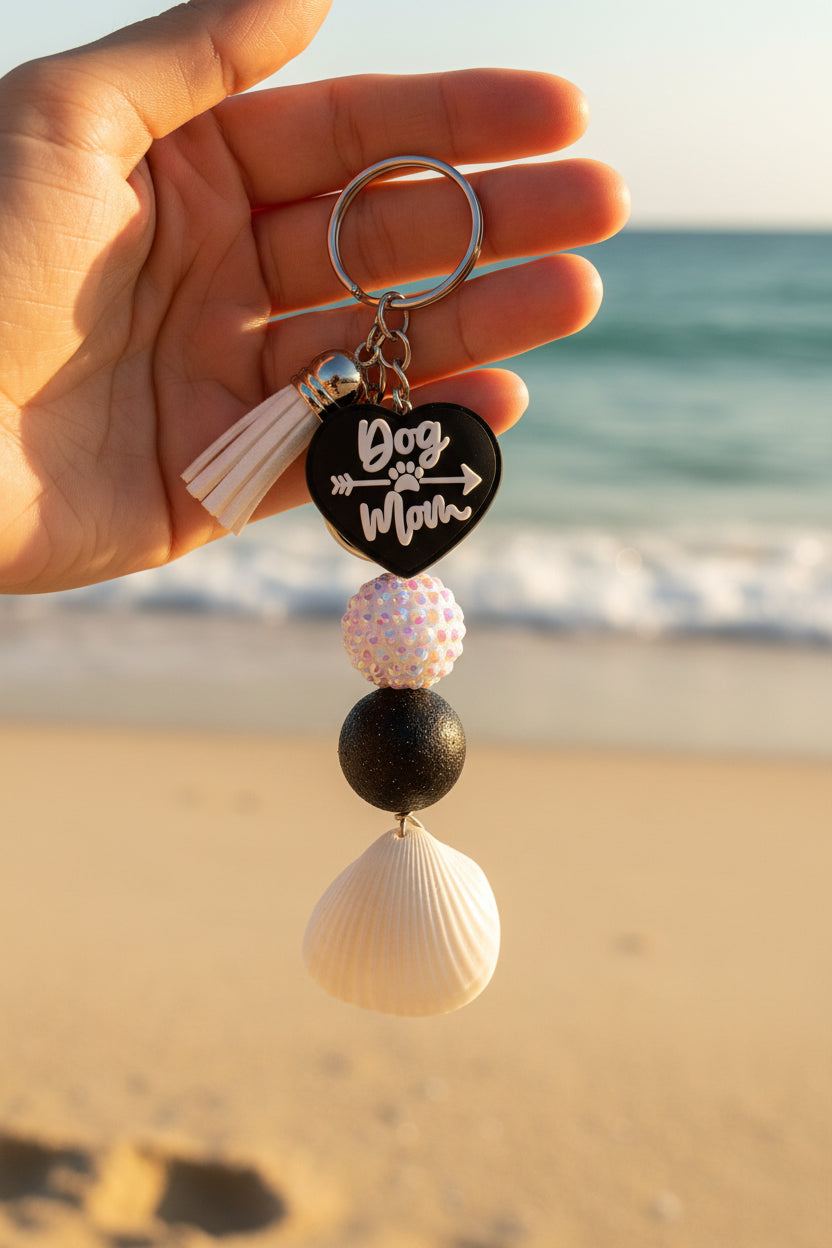 Dog Mom ark shell keychain on handmade card with quarter for scale on blue background