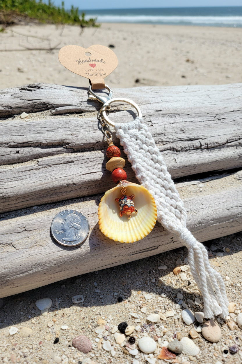 Turtle Cove prickly cockle shell macrame keychain full view on woven straw bag showing macrame strap and tassel
