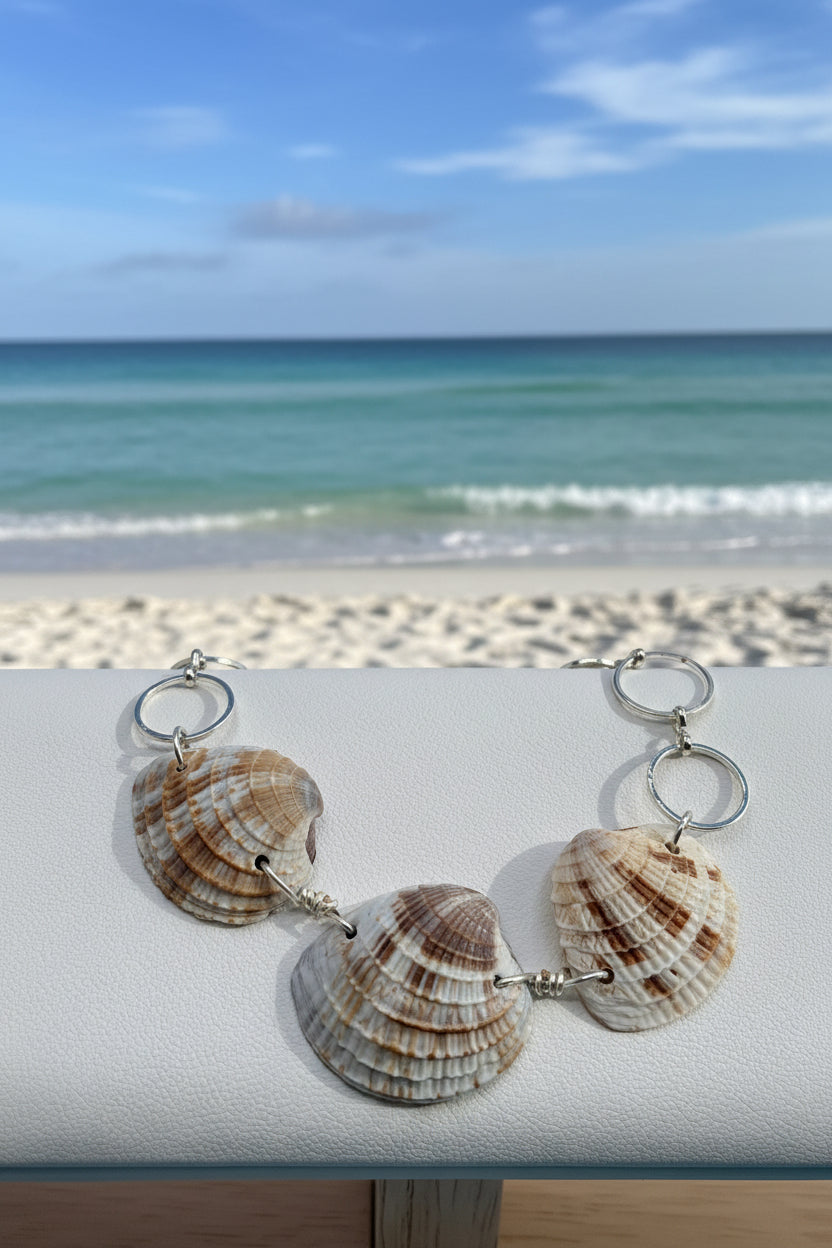 Calico scallop shell bracelet on white jewelry display