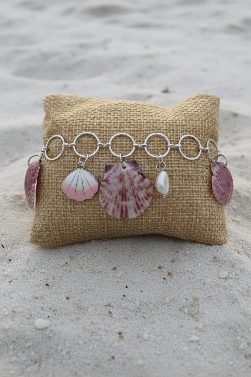 Shell charm bracelet on burlap pillow display
