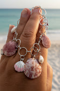 Shell charm bracelet on wooden display stand