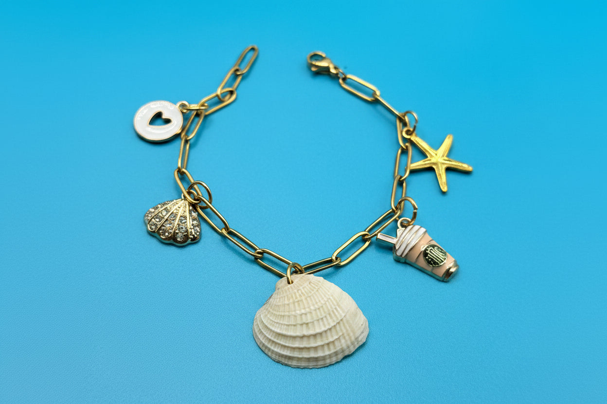 Ribbed venus clam shell charm bracelet on white jewelry display stand