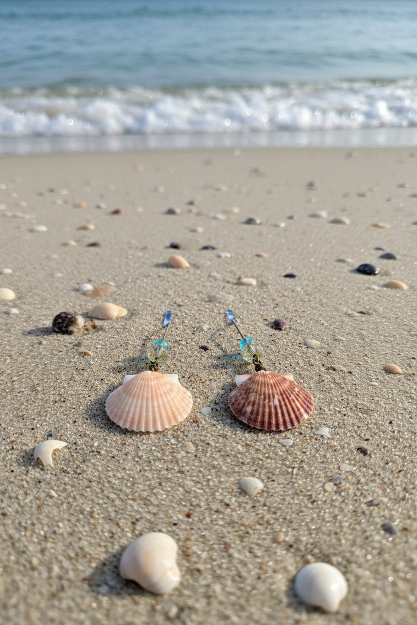 Close-up of calico scallop shell earrings on display board showing bead stack detail