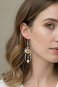 Calico scallop shell chandelier earrings on ruler showing 4 inch drop