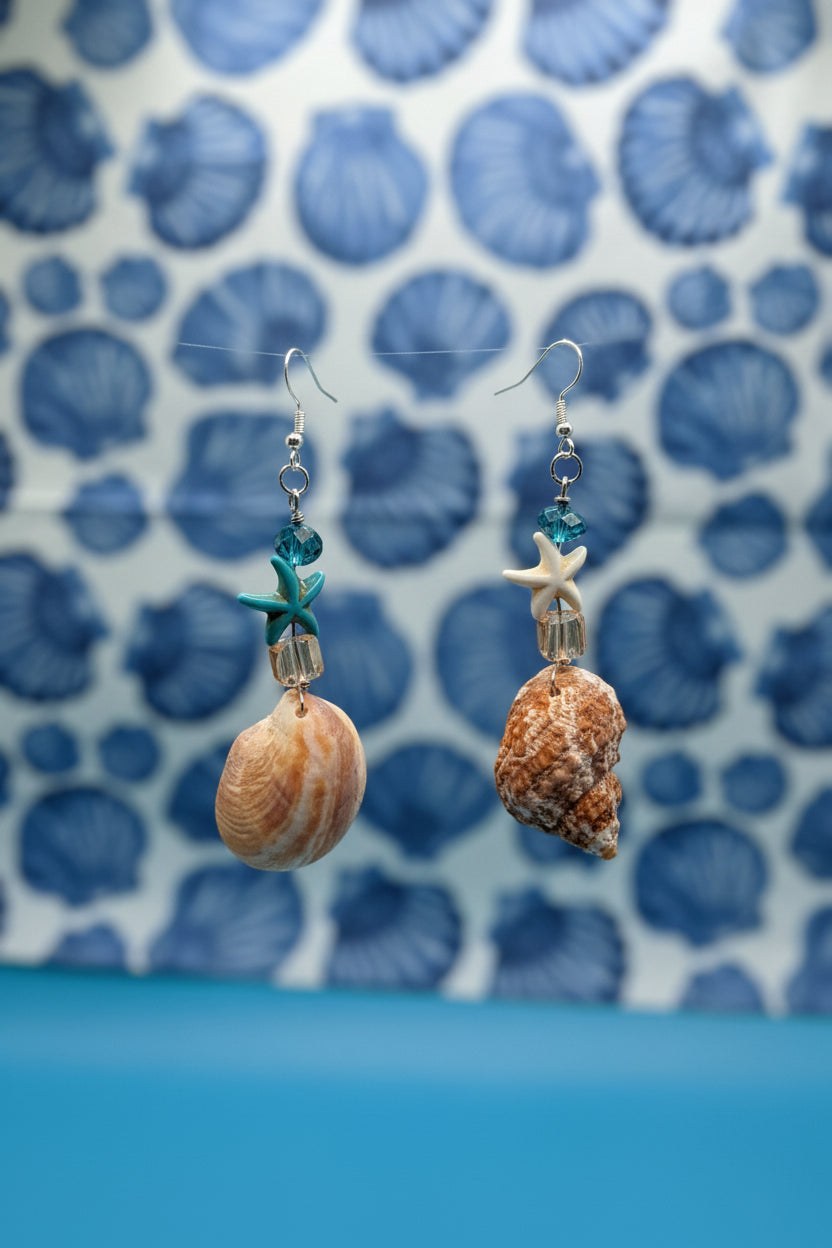 Mismatched turban and slipper shell earrings on display board with ruler