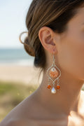 Kitten paw shell chandelier earrings on white earring display stand