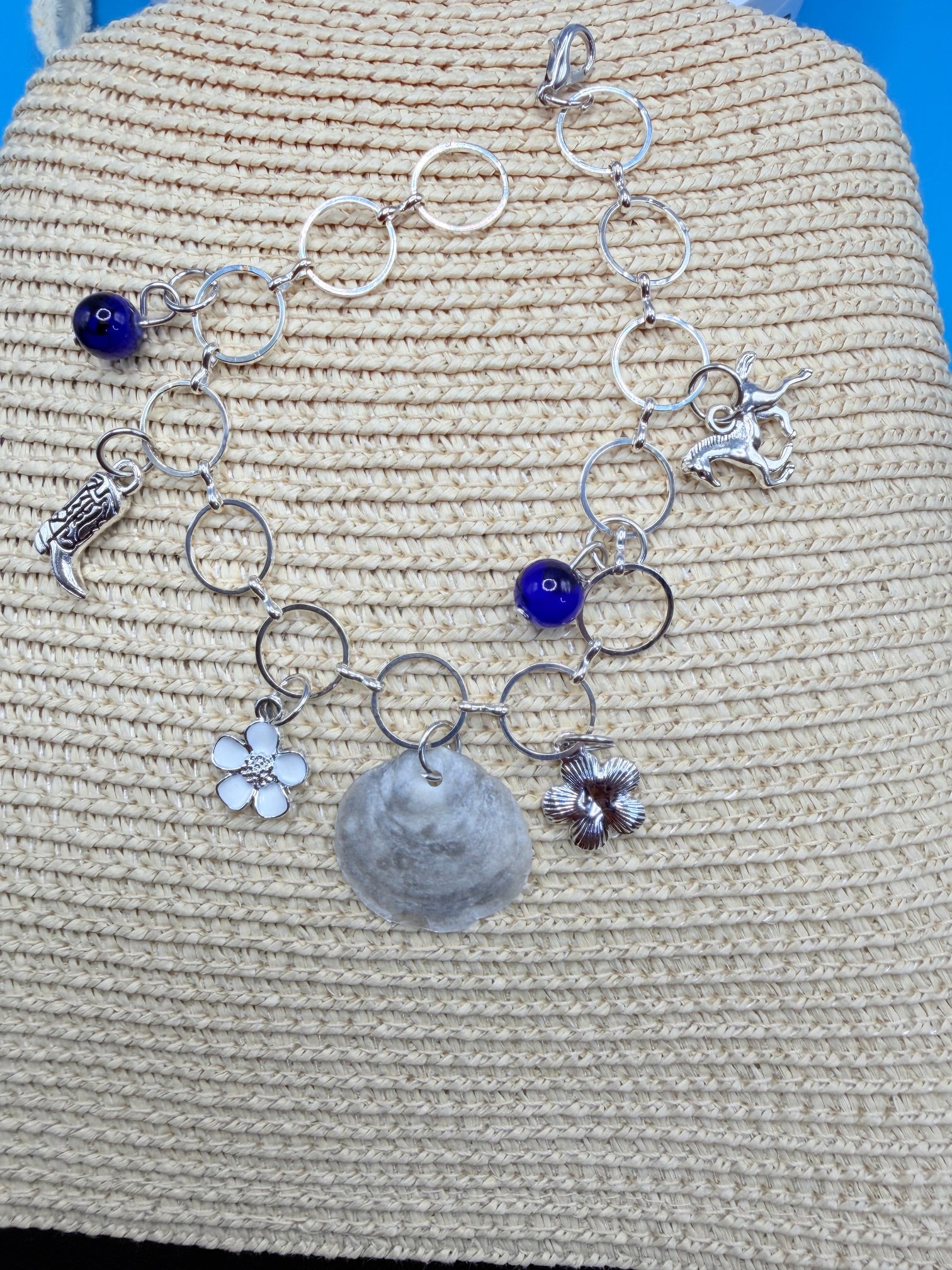 Jingle shell charm bracelet flat lay showing all charms