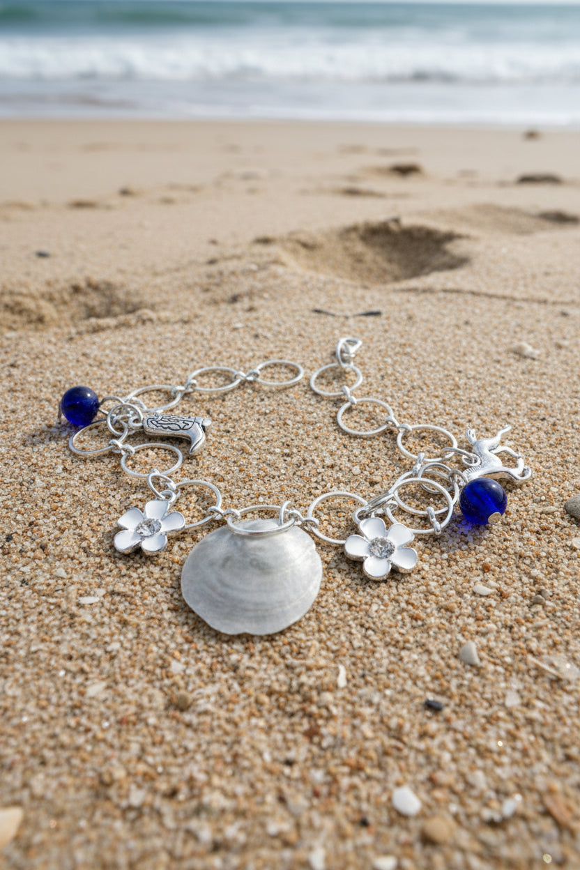 Jingle shell charm bracelet draped on straw hat