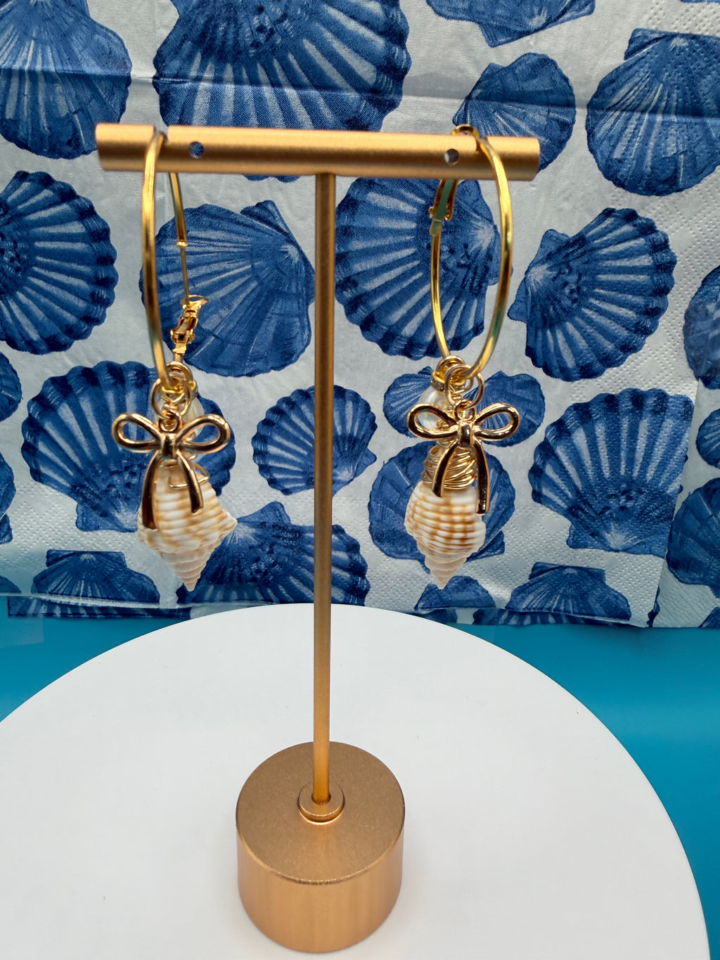 Juvenile conch shell hoop earrings pair with quarter for scale