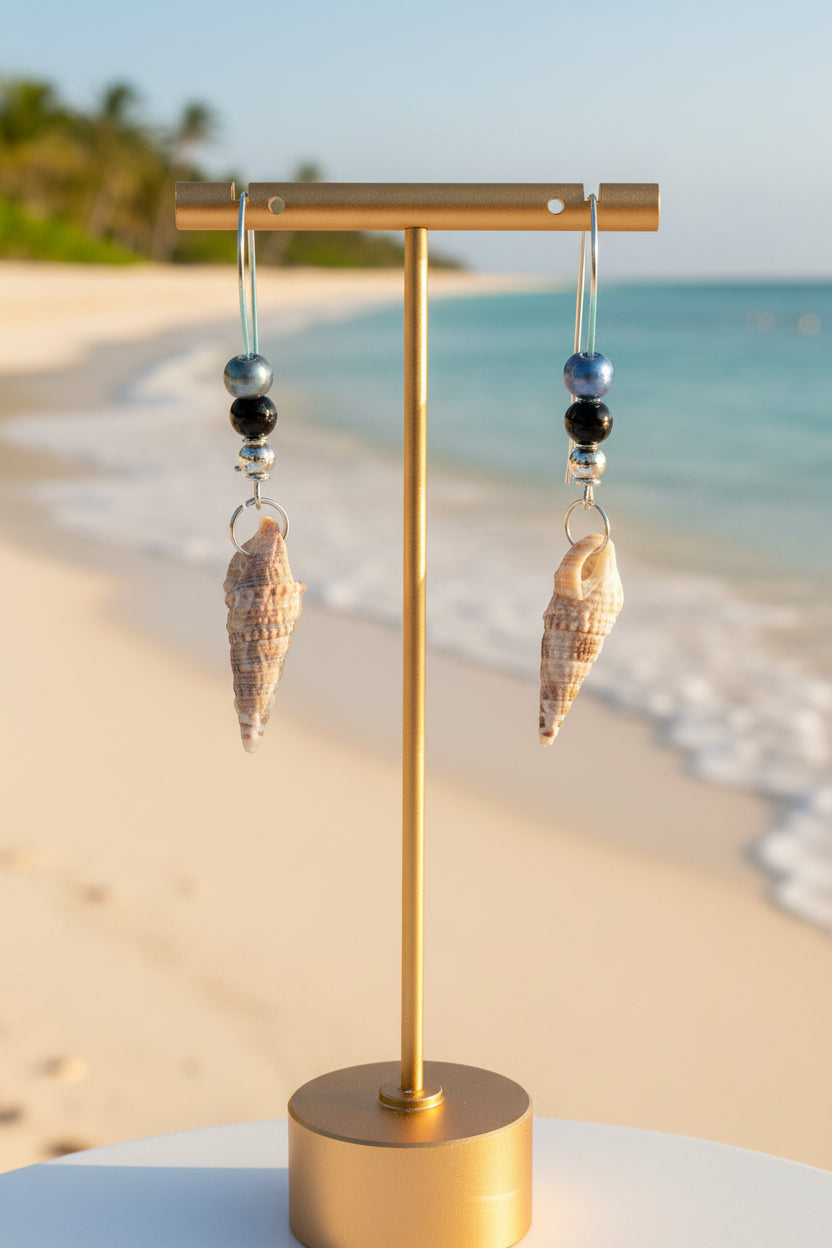 Auger shell earrings on gold display stand close-up