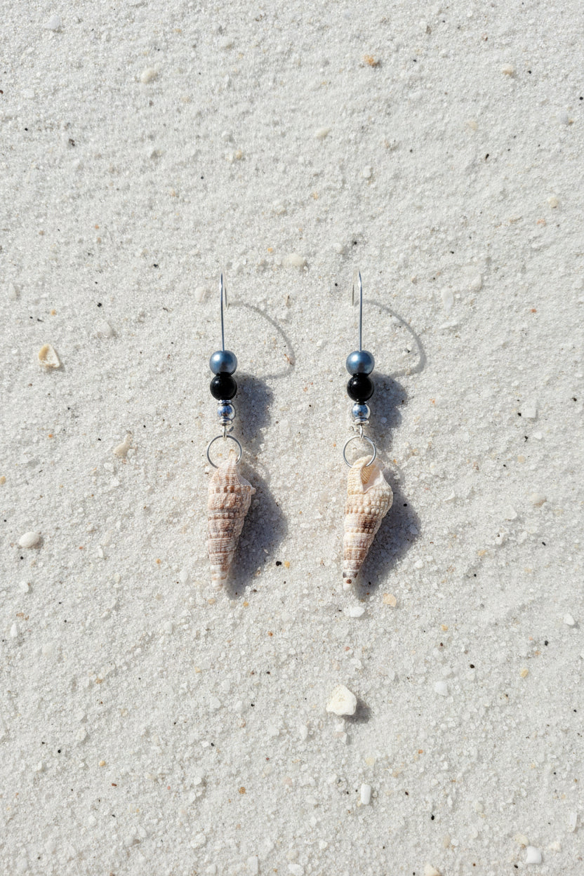 Auger shell earrings on gold display stand with blue shell backdrop