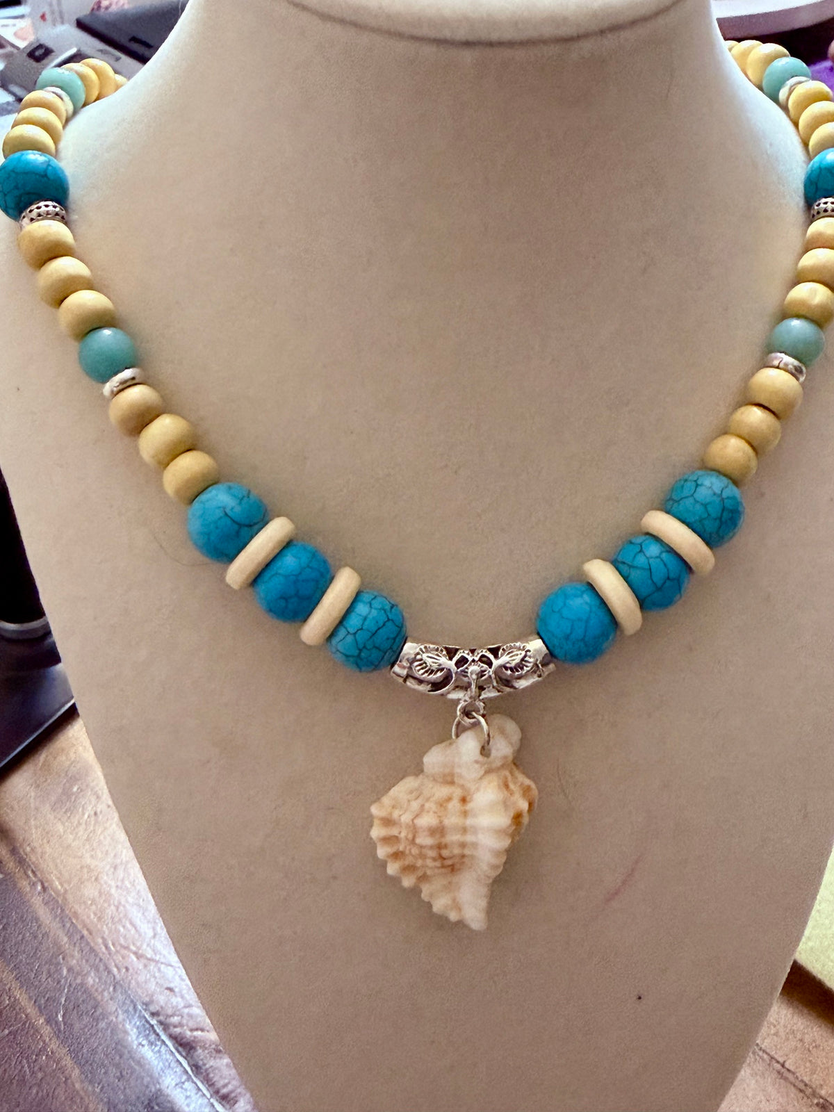 Full view of the 19 inch turquoise beaded conch shell necklace