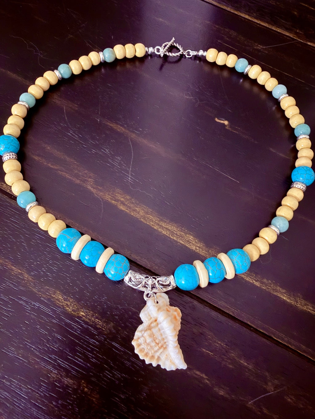 Turquoise beaded conch shell necklace detail