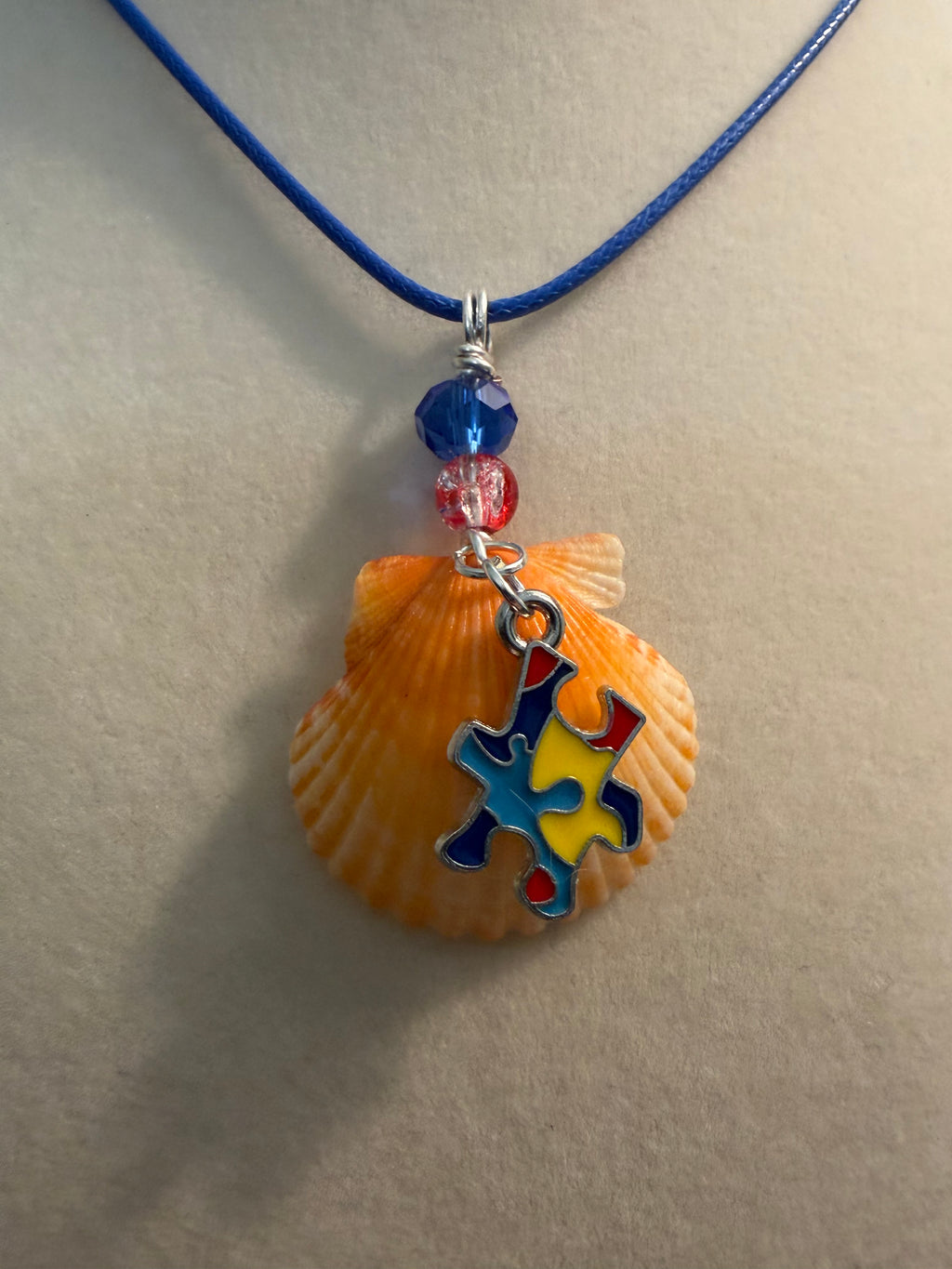 Unbreakable Light – Autism Awareness Scallop Shell Necklace on Blue Waxed Cord