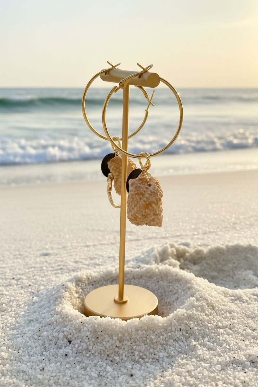 Shoreline Keepsakes gold hoop earrings featuring natural turban shells, matte black beads, and dangling jellyfish charms.